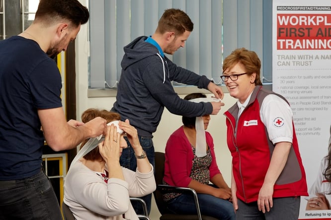 A group of British Red Cross Training course attendees learning how to 